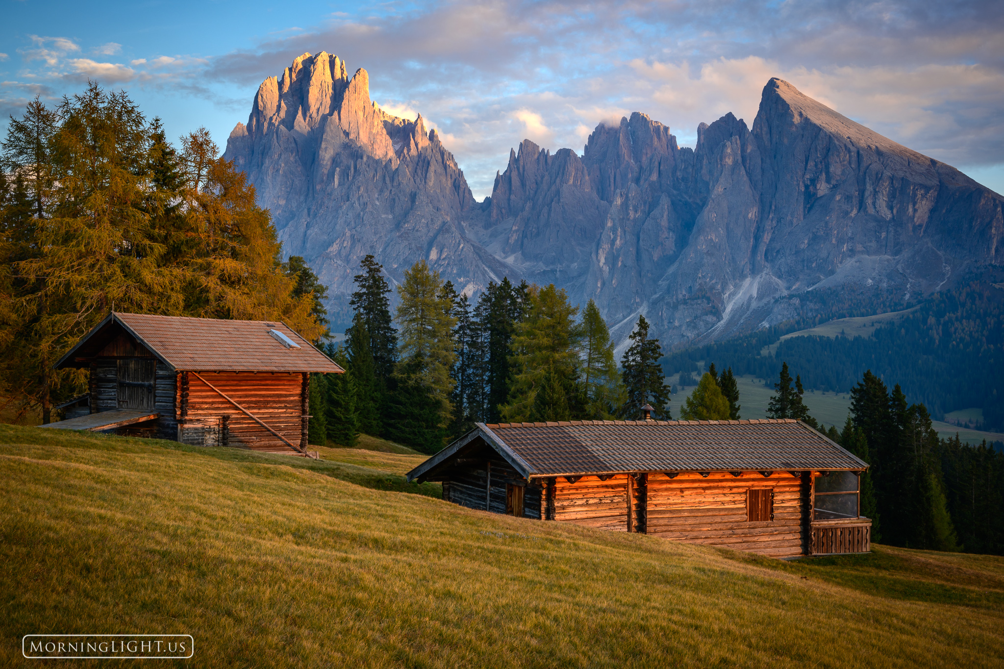 The last rays of the day gently touch this barn and cabin in the dramatic Dolomites in northern Italy.